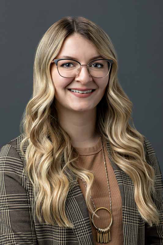 headshots office portrait of executive wearing glasses