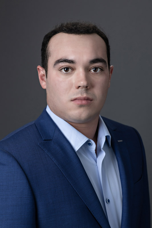 executive headshot portrait man wearing blue suit