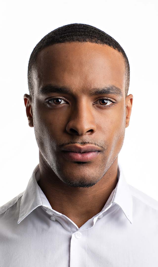 A headshot for an actor/model white shirt white background