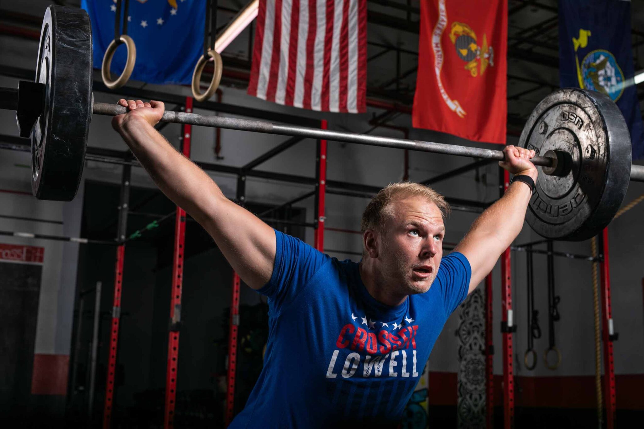 C18_CrossfitLowell_013_web crossfit athlete with barbell overhead, mid lift