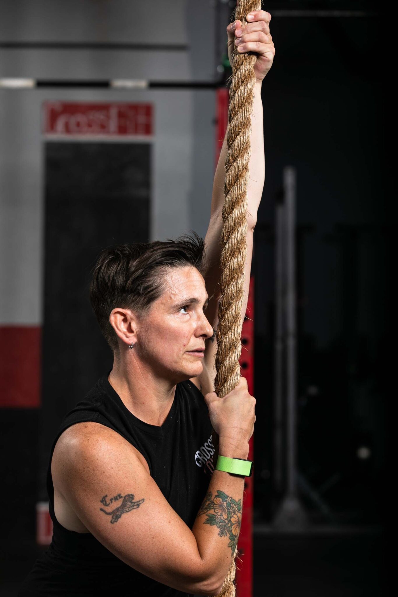 C18_CrossfitLowell_025_web crossfit athlete holding onto a rope after training