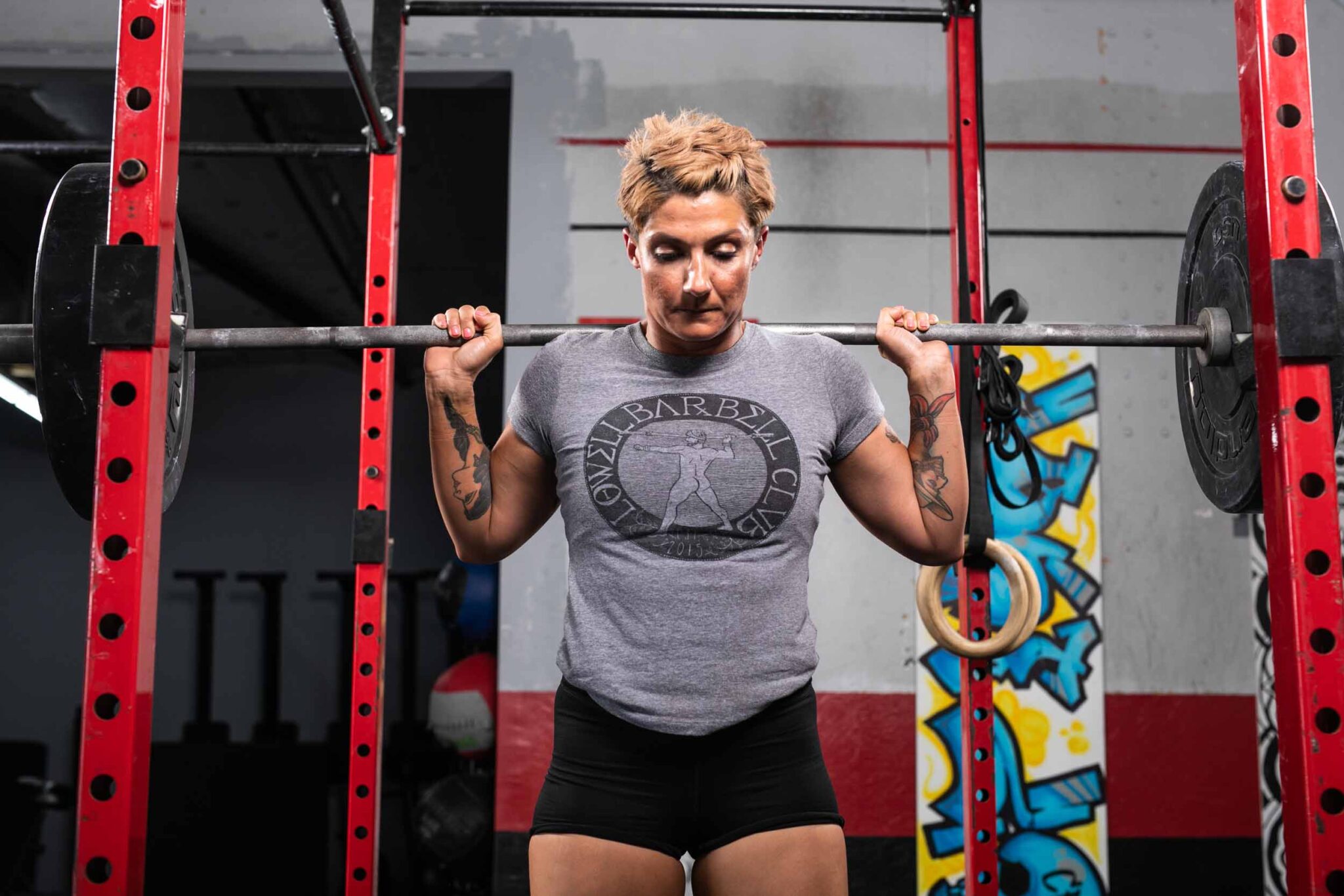 C18_CrossfitLowell_077_web crossfit athlete resting on squat rack